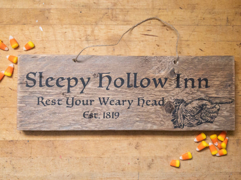 Reclaimed wood sign with twine hanger and black text and candy corn