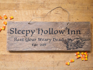 Reclaimed wood sign with twine hanger and black text and candy corn